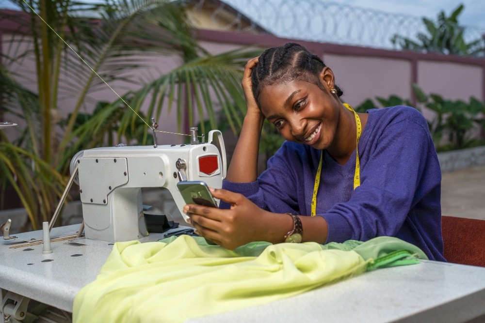 A lady sowing cloth with a machine