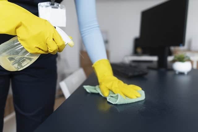 someone cleaning a table