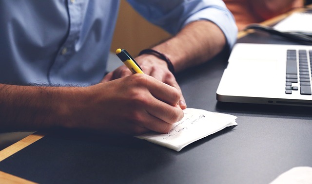 man studying writing 