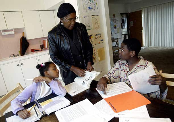 woman teaching two children's