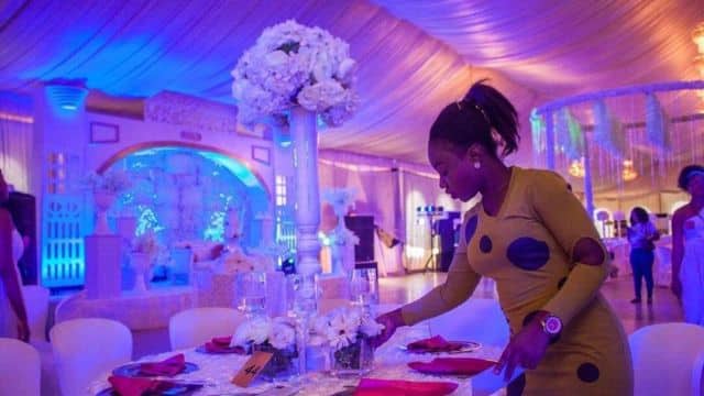 Female Event planner arranging flowers.