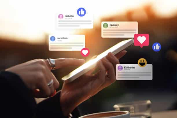 Young woman receiving notifications and commenting on social media posts with smart phone. People networking with technology. Social media marketing concept.