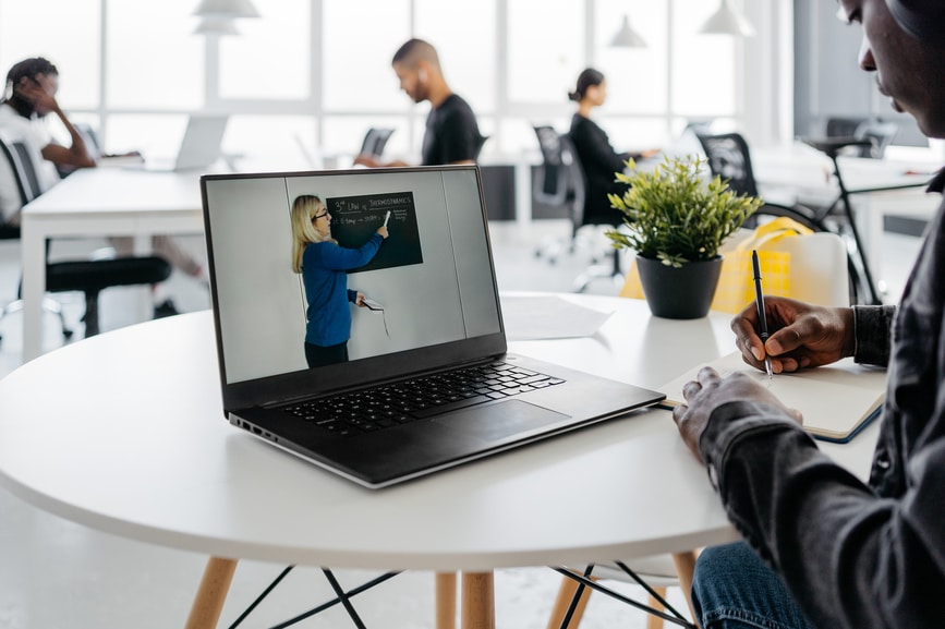 A Student Attending a class online with a laptop.